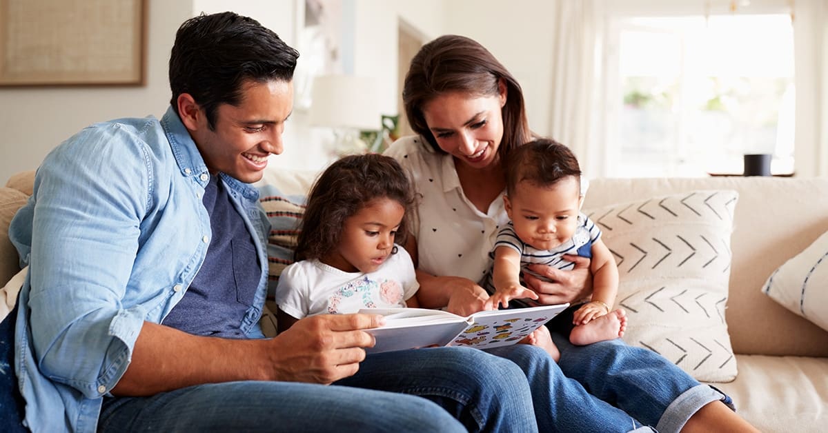 hispanic-family-two-children-reading-together