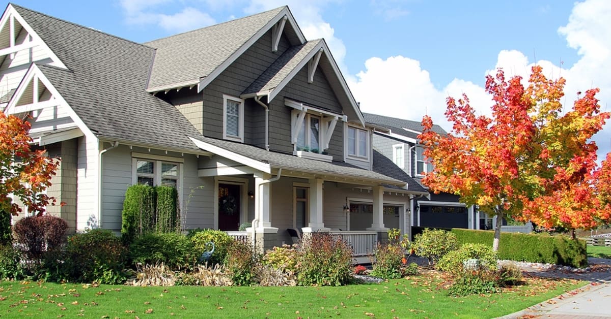 Beautiful new home with a cozy porch in autumn.