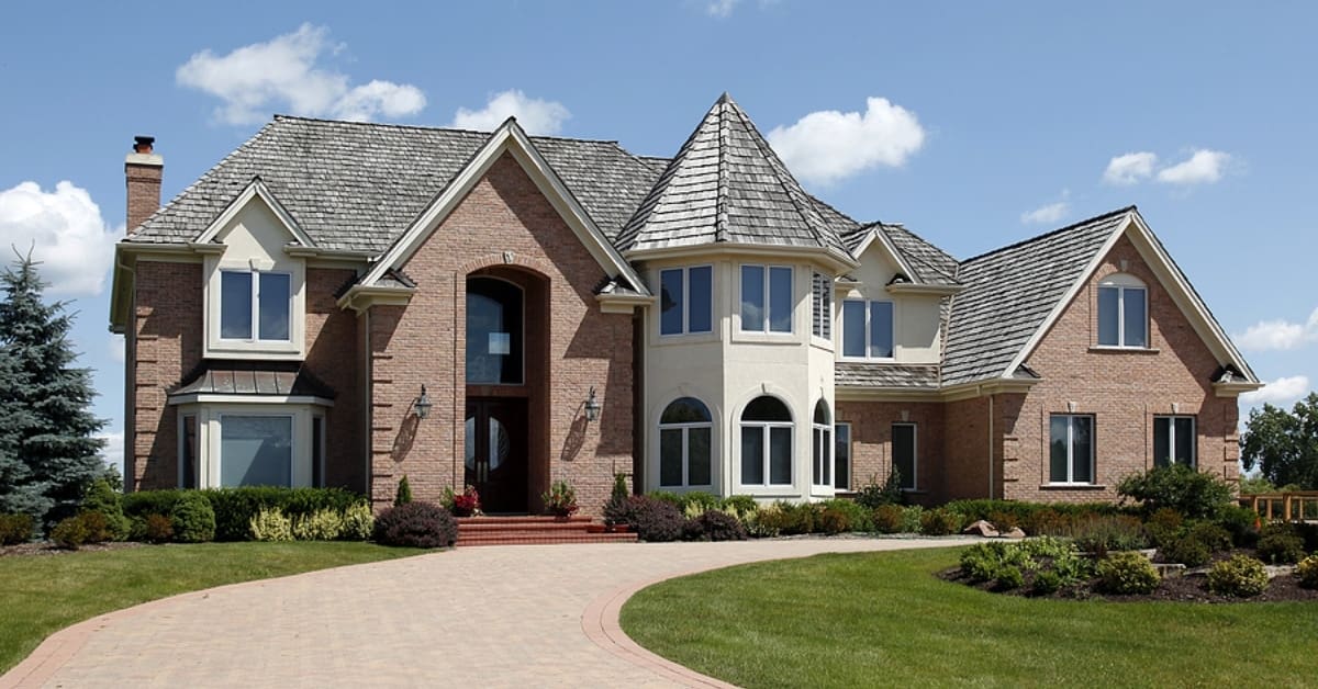 Large home in suburbs with turret and arched entry