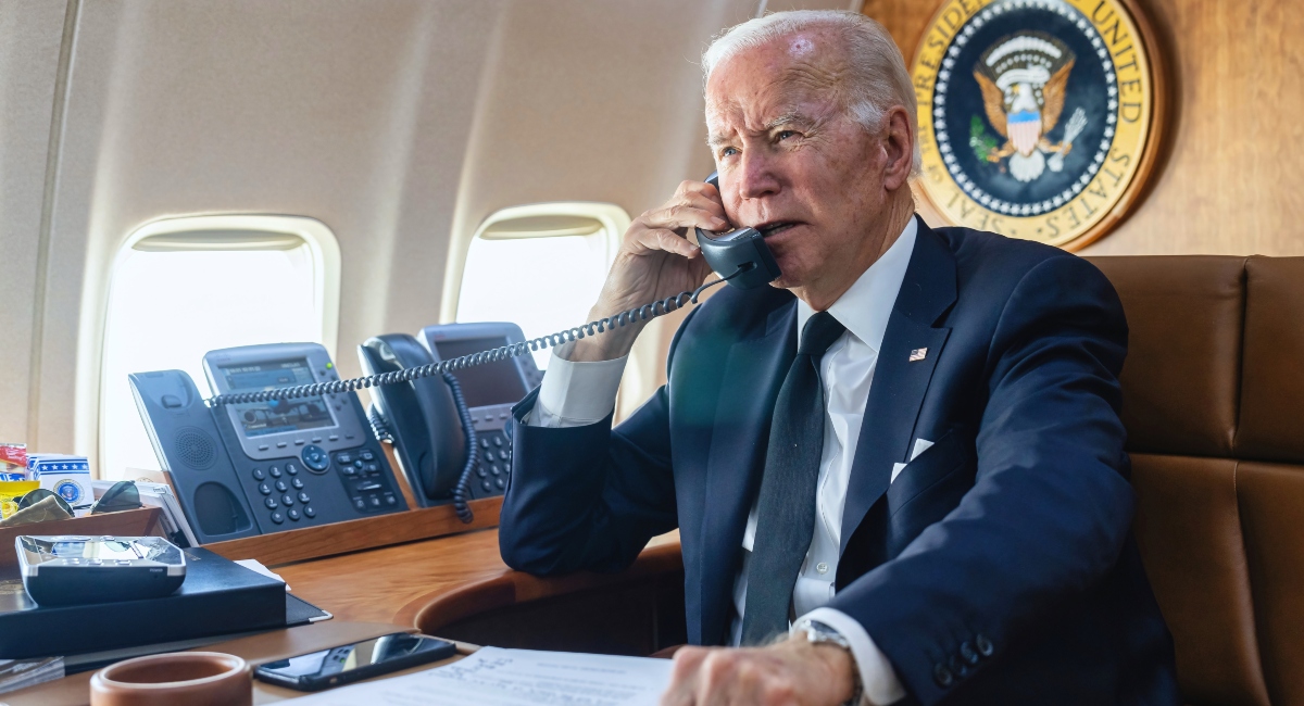 President Biden on airplane talking on the phone