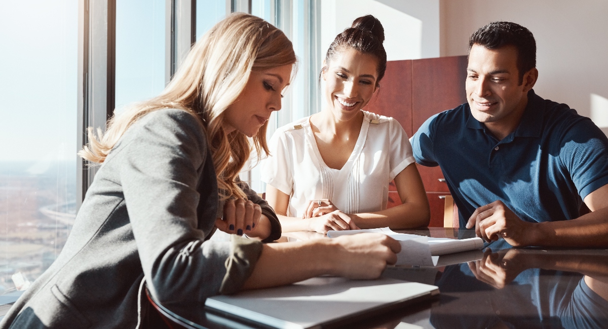 Group of people sitting at table in meeting for updates