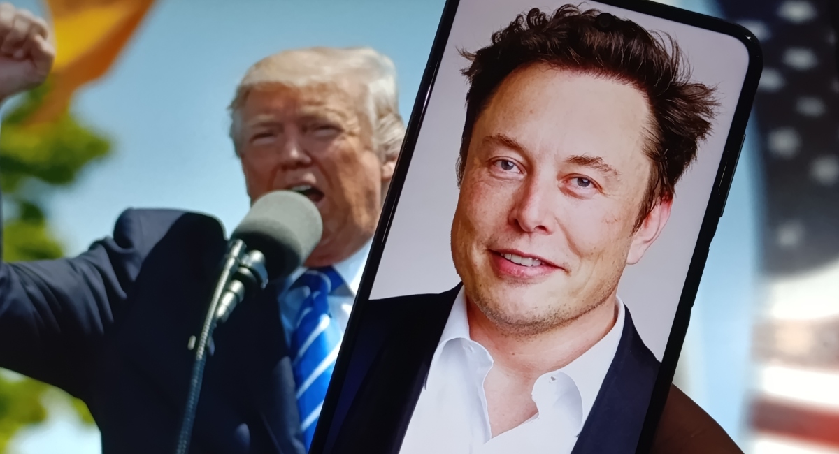 Donald Trump speaking passionately with Elon Musk’s portrait on a smartphone