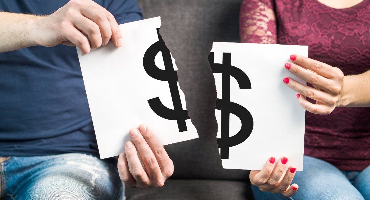 Man and woman holding ripped paper with dollar sign